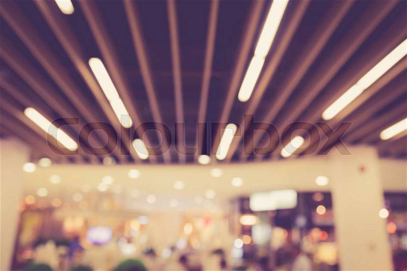 Blurred image of people in shopping mall with bokeh, vintage color, stock photo