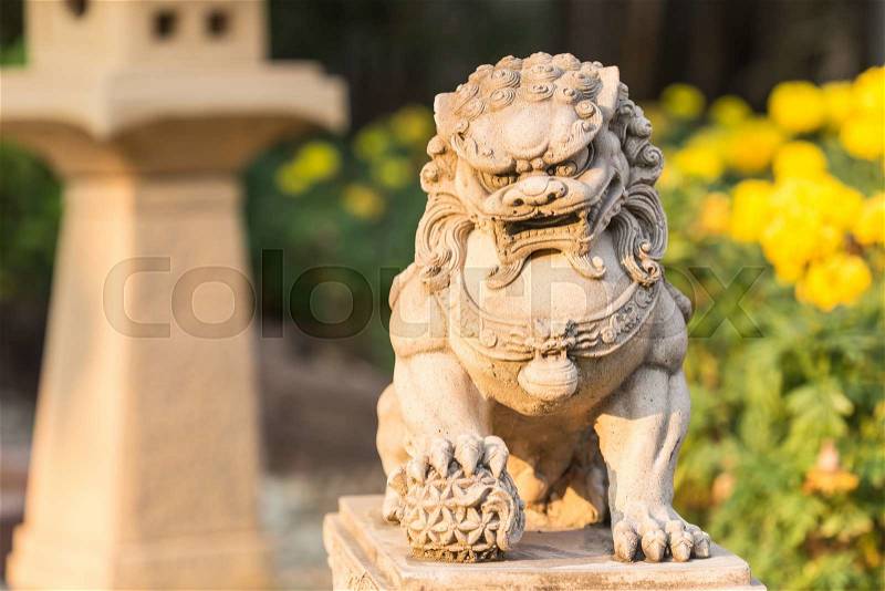 Close up vintage sandstone lion statue stand in the garden, stock photo
