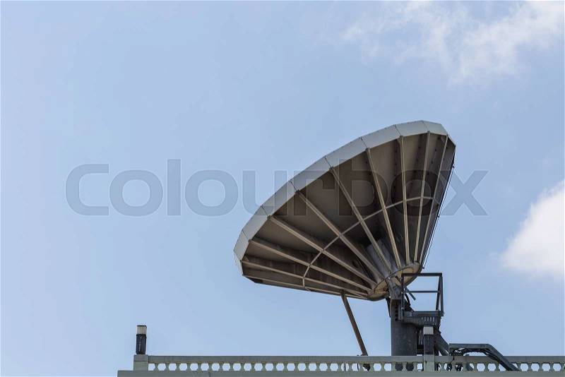 Big satellite dish on the roof with blue sky background, stock photo