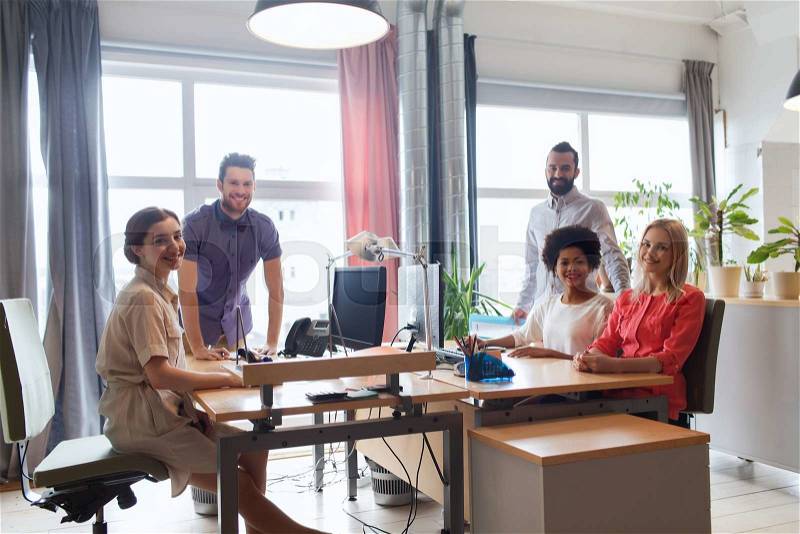 Business, startup and people concept - happy creative team in office, stock photo