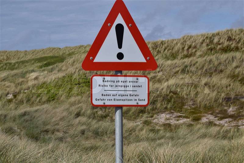 Caution sign at beach, stock photo