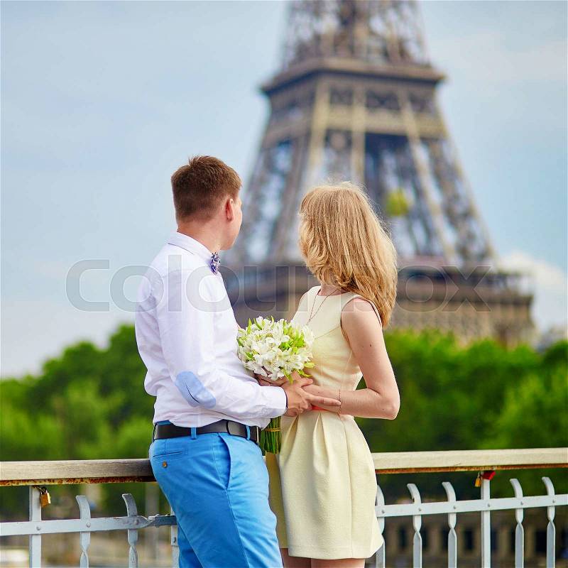 Young just married couple in Paris near the Eiffel tower , stock photo