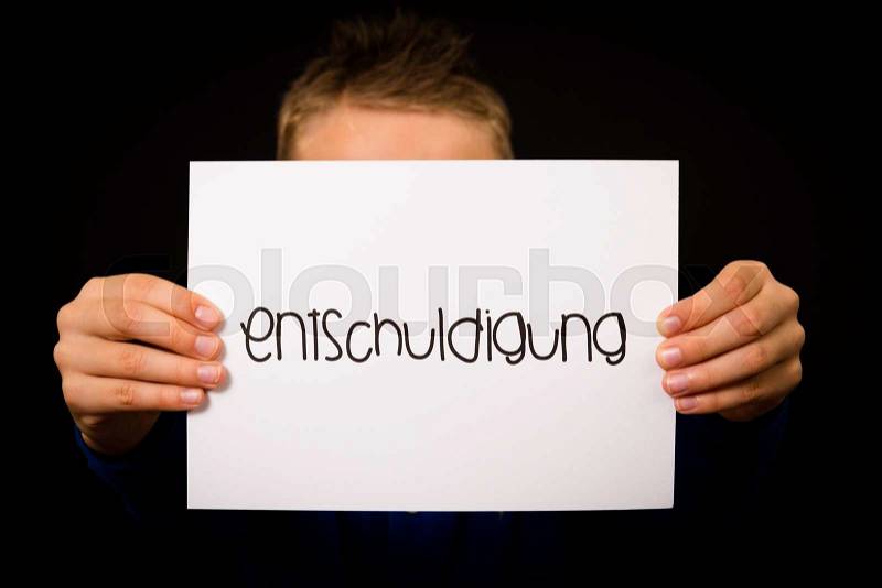 Studio shot of child holding a sign with German word Entschuldigung - Sorry, stock photo