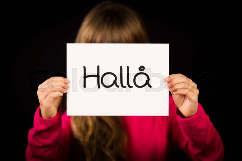 Studio shot of child holding a sign with Swedish word Halla - Hello, stock photo