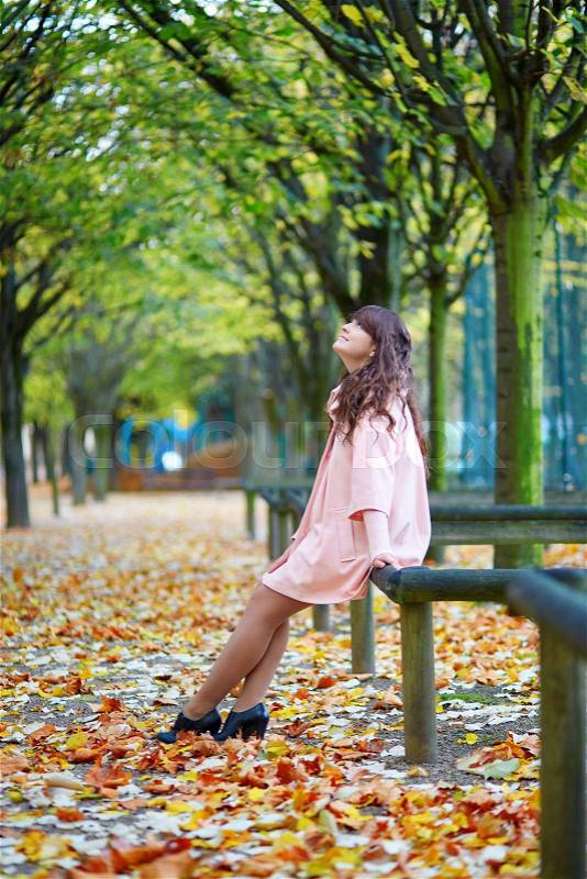 Thoughtful young woman in Paris on a fall day, stock photo