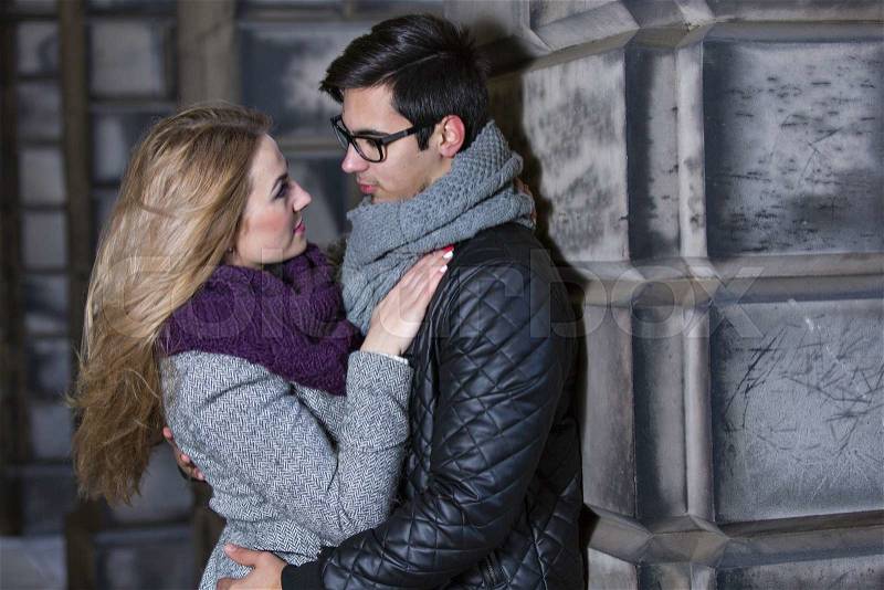 Attractive young stylish couple in love dressed in warm cloths outdoors , stock photo