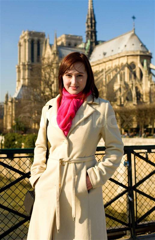 Beautiful woman in Paris near Notre-Dame de Paris, stock photo