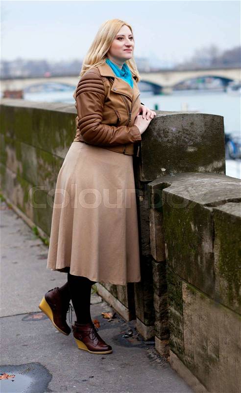 Beautiful blonde woman in Paris, on the Seine embankment, stock photo