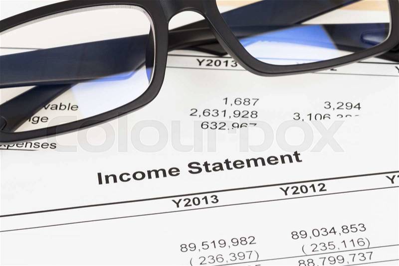 Income statement financial report with glasses; statement is mock-up, stock photo