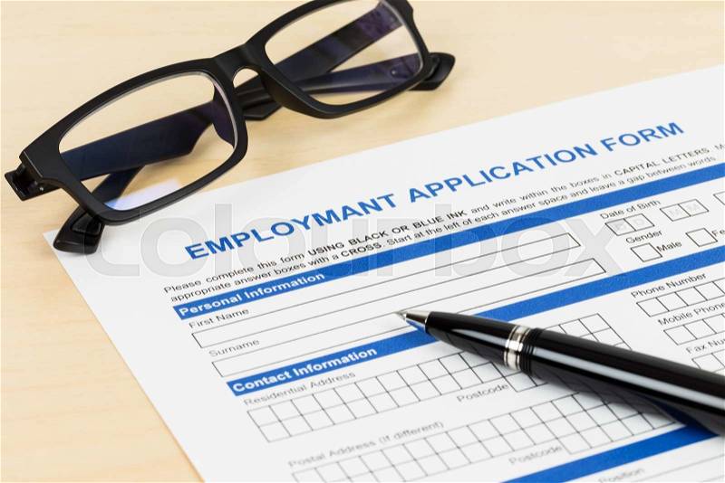 Employment application form with pen and glasses; form is mock-up, stock photo