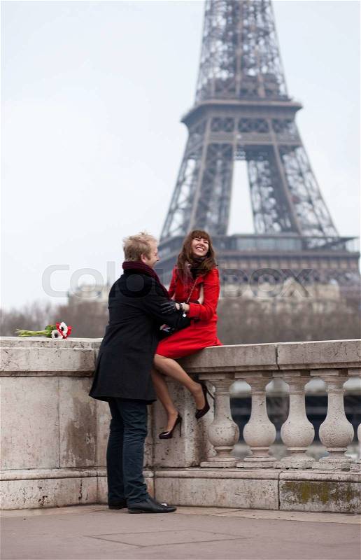 Romantic couple in love in Paris, near the Eiffel tower, stock photo
