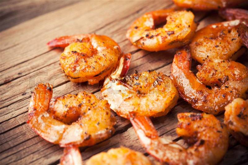 Shrimps fried on a wooden background, stock photo
