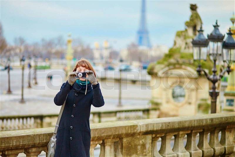 Tourist in Paris taking a picture, stock photo