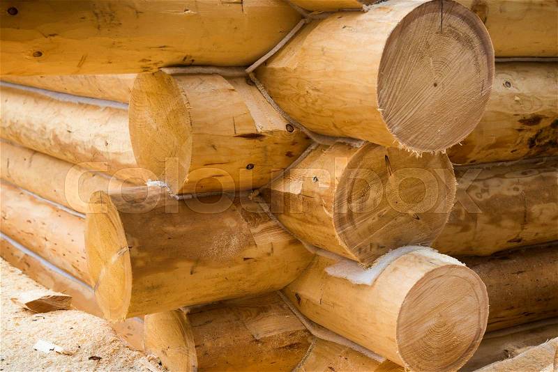 Wall under construction of country wooden house. Details of the loghouse, stock photo