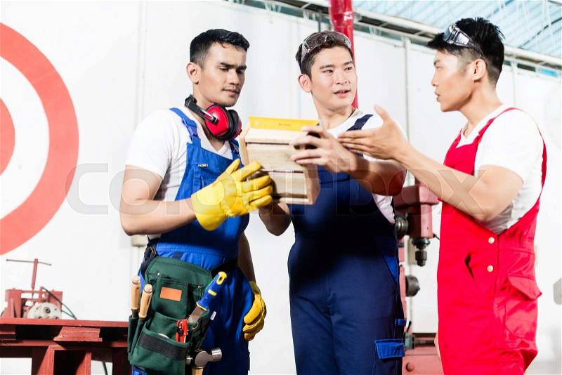 Team of Asian workers discussing product as a work team, stock photo