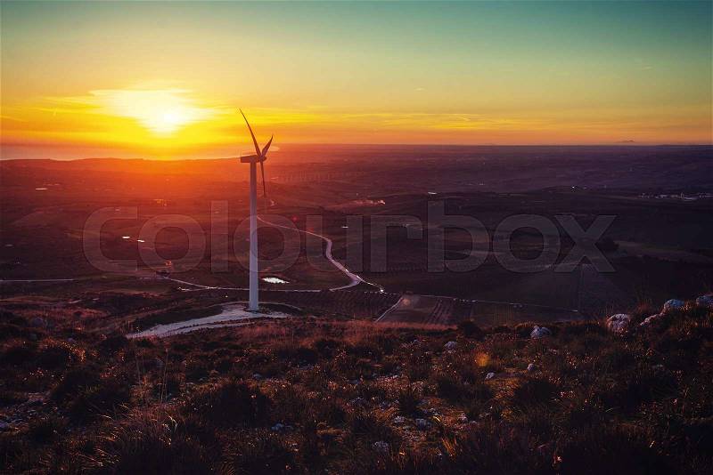 Solar wind turbines at sunset, stock photo