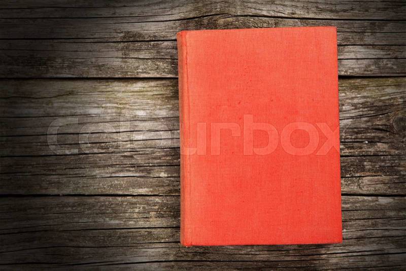 Old open book on wooden background, stock photo