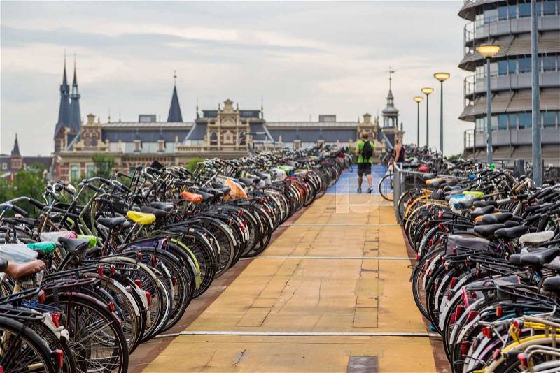Huge bicycle parking in the center of Amsterdam in a summer day, stock photo