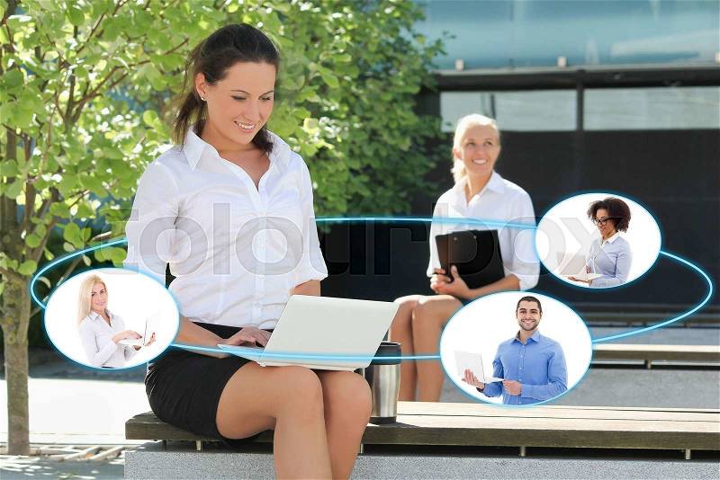 International business and internet concept - business woman talking with her business partners in summer park, stock photo