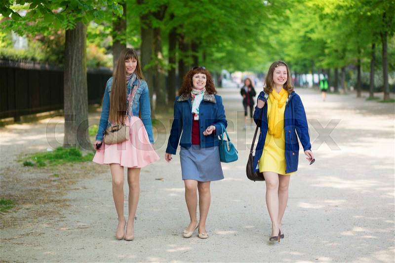 Happy friends walking together in Paris, stock photo