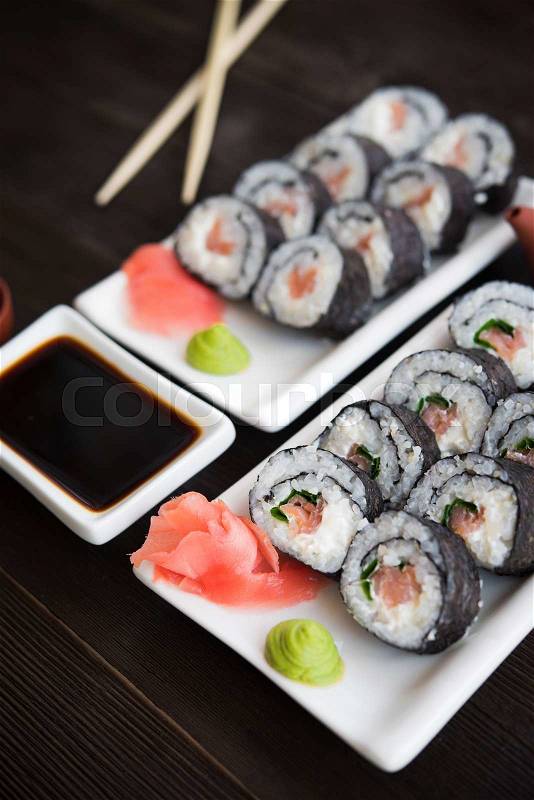 Sushi and roll with cream cheese and salmon fish inside, stock photo