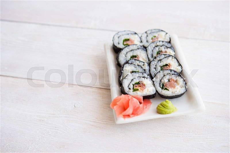 Sushi and roll with cream cheese and salmon fish inside, stock photo