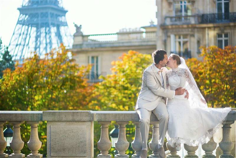 Happy just married couple in Paris on a fall or spring day , stock photo