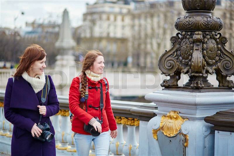 Two friends in Paris on the Pont Alexandre III, stock photo