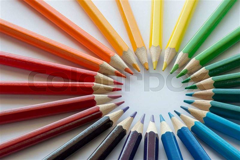 Abstract composition of complementary cirkel with color pencils against a white background, stock photo