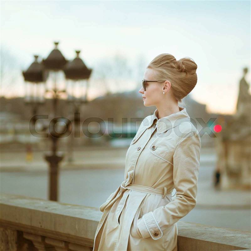 Elegant young Parisian woman outdoors, stock photo