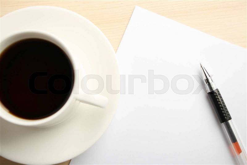 Blank white paper is on the table with ball pen and coffee aside, stock photo