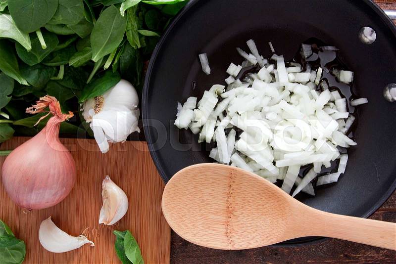 Cut onion in a frying pan before frying, stock photo