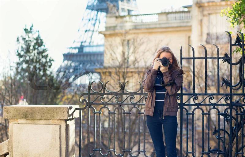 Young girl taking a street photo in Paris, stock photo