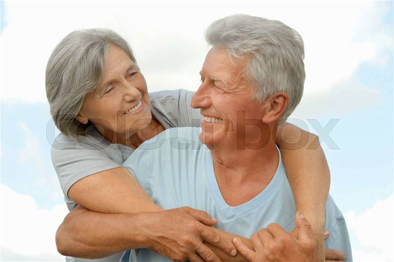Happy senior couple on a sky background, stock photo