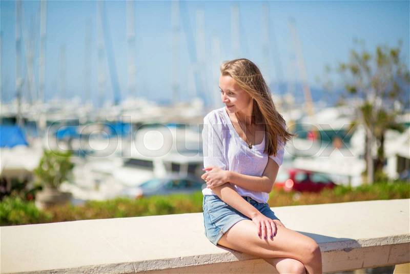 Nice looking young girl enjoying her vacation by the sea, stock photo