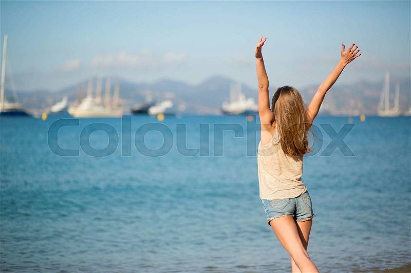 Beautiful young girl enjoying her vacation by the sea, stock photo