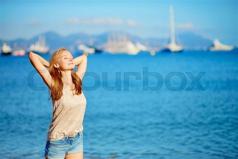 Beautiful young girl enjoying her vacation by the sea , stock photo