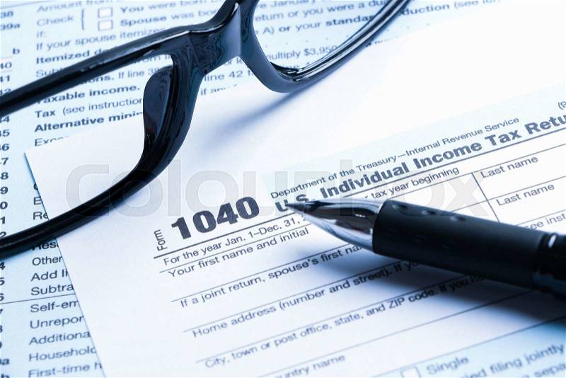 Tax form business financial concept with a pair of black glasses and a pen aside, stock photo