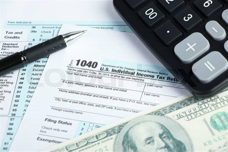 Tax form financial concept with some money and some other business objects aside, stock photo
