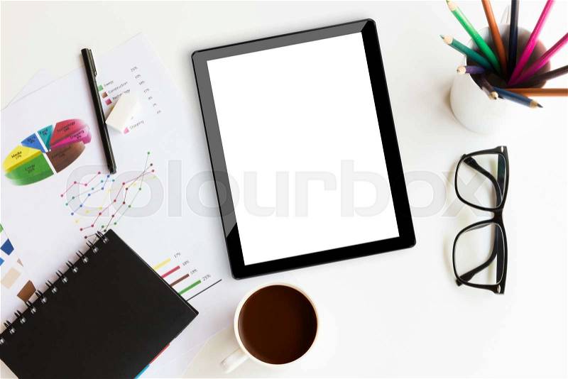Tablet on desk workspace in office background, stock photo