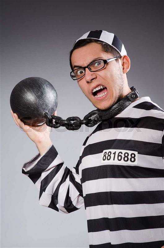 Funny prisoner in chains isolated on gray, stock photo