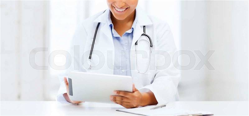 Healthcare, medical and technology concept - african female doctor with tablet pc, stock photo