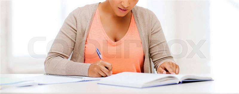 Education and business concept - international student studying in college, stock photo