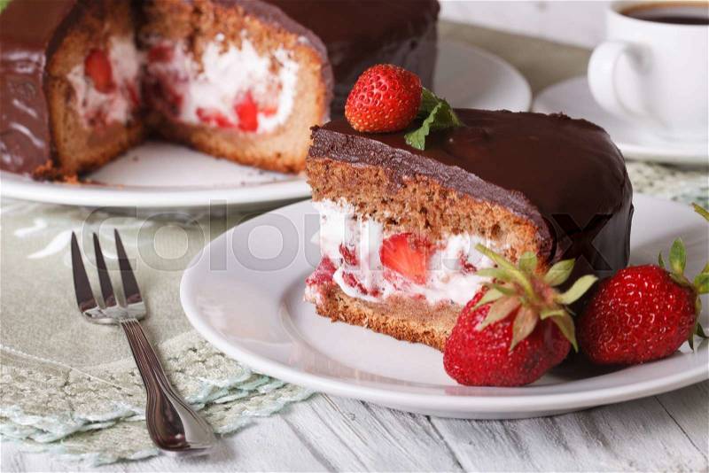 Cut cake with strawberry and chocolate on a table close-up. horizontal , stock photo