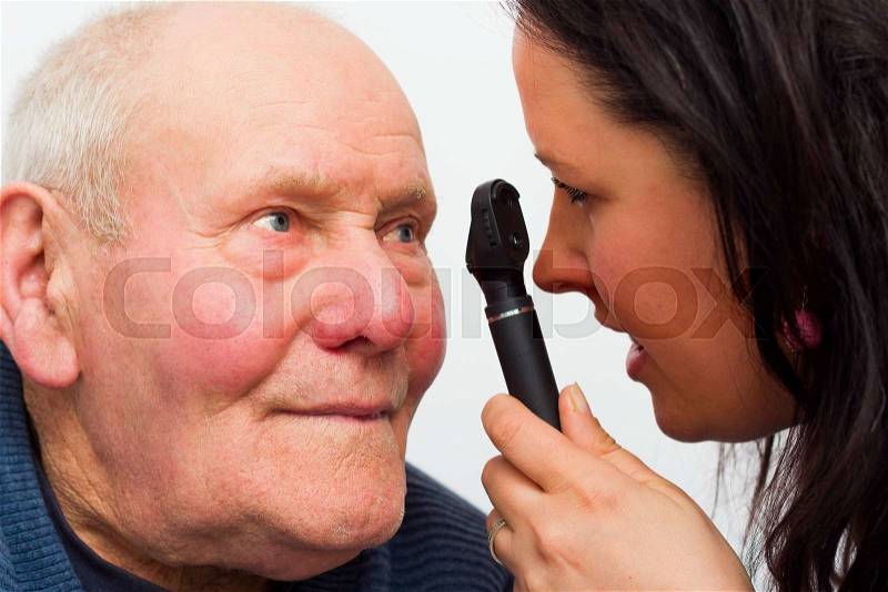 Elderly man at the optician\'s for vision test, stock photo