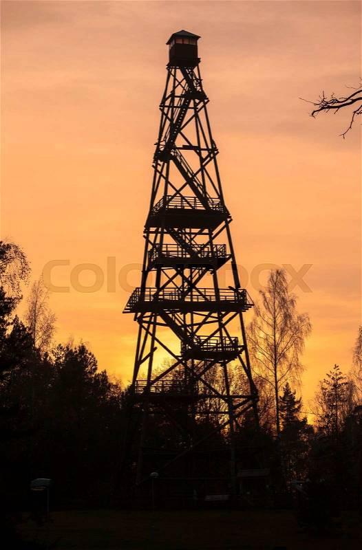Silhouette of tall forest fire watch tower, stock photo