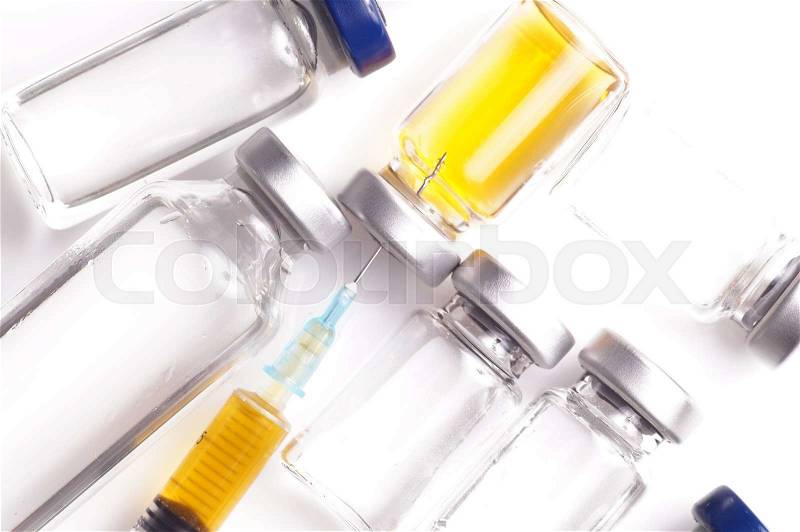 Vials with liquid and syringe filled with yellow substance, stock photo