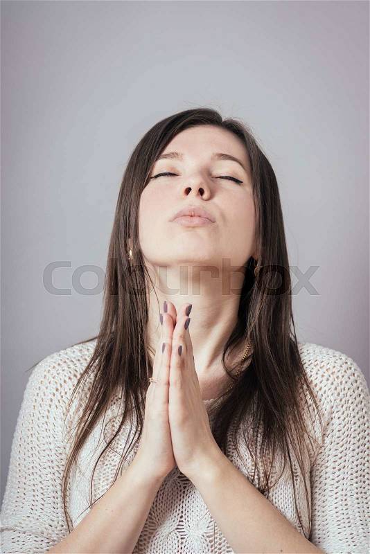 Girl praying, stock photo