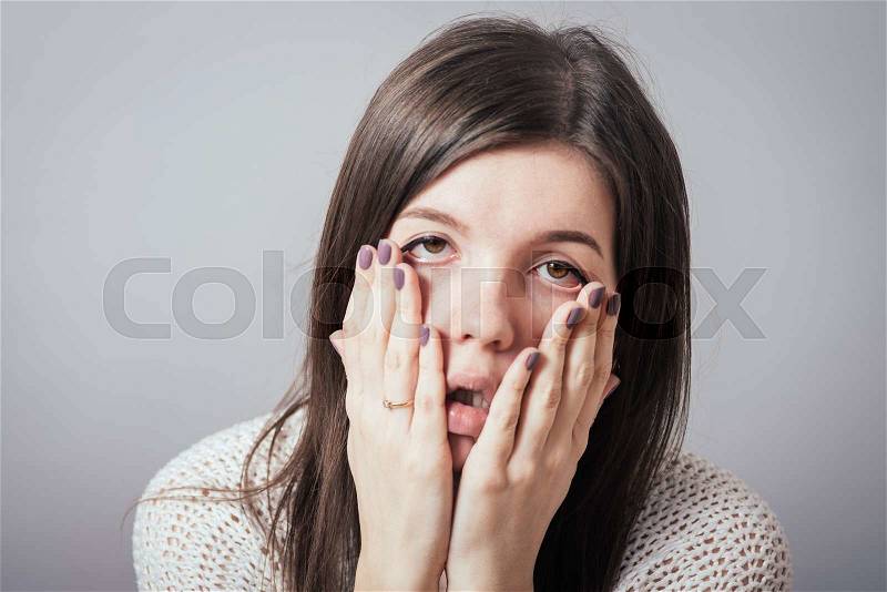 Girl pulls the skin on the face, stock photo