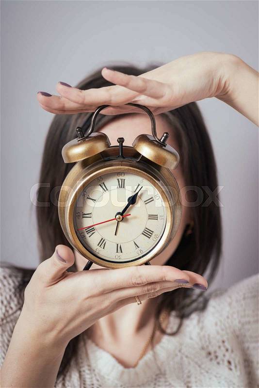 Girl holding a clock, stock photo